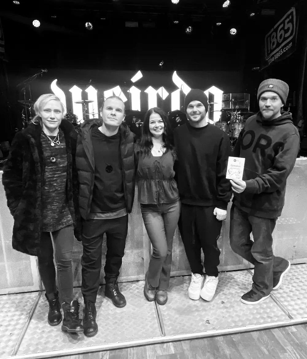 Me posing with the band members of The Rasmus in front of a stage.