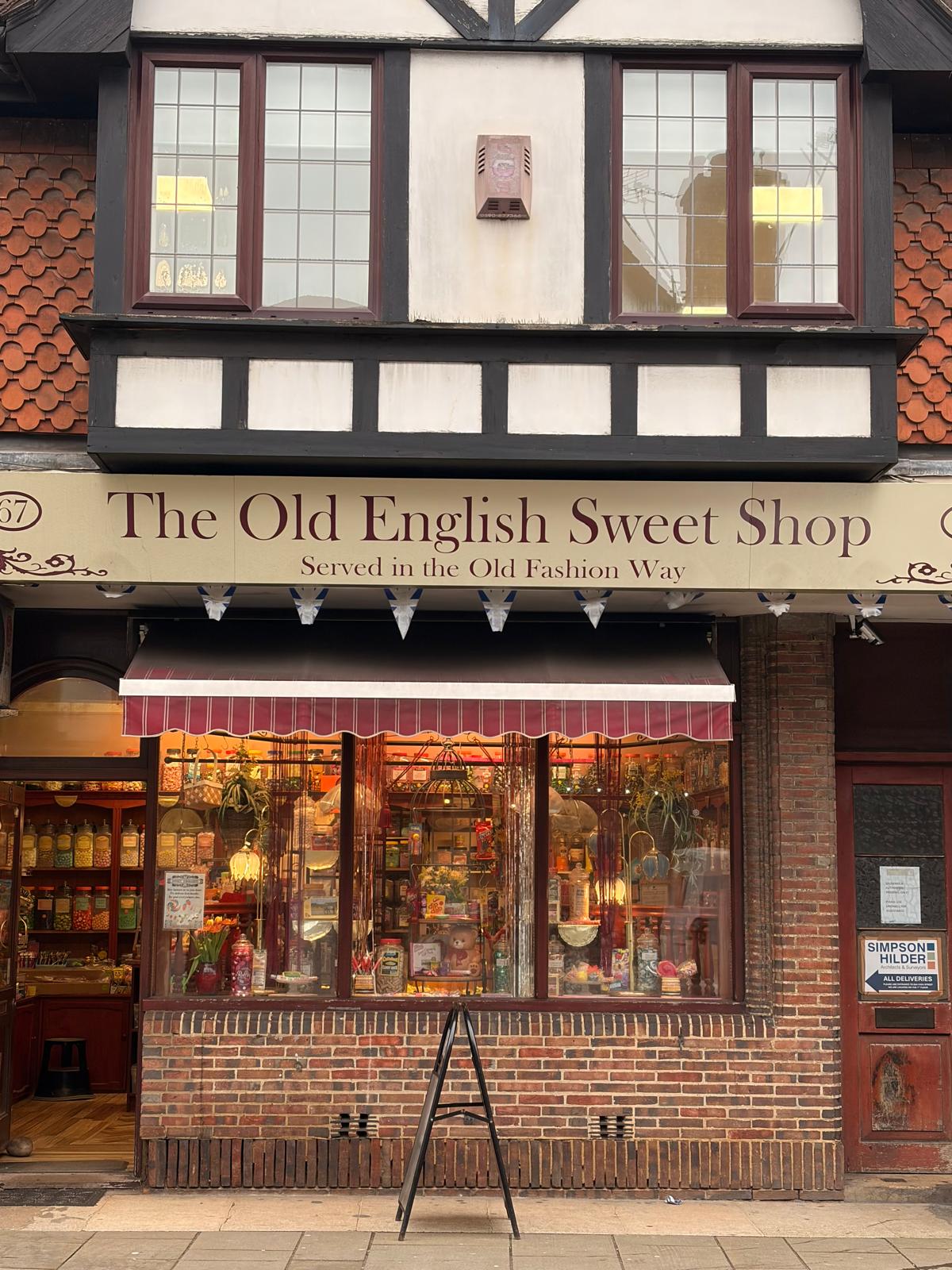 The facade of a sweet shop that had cosy lights and a very traditional style.