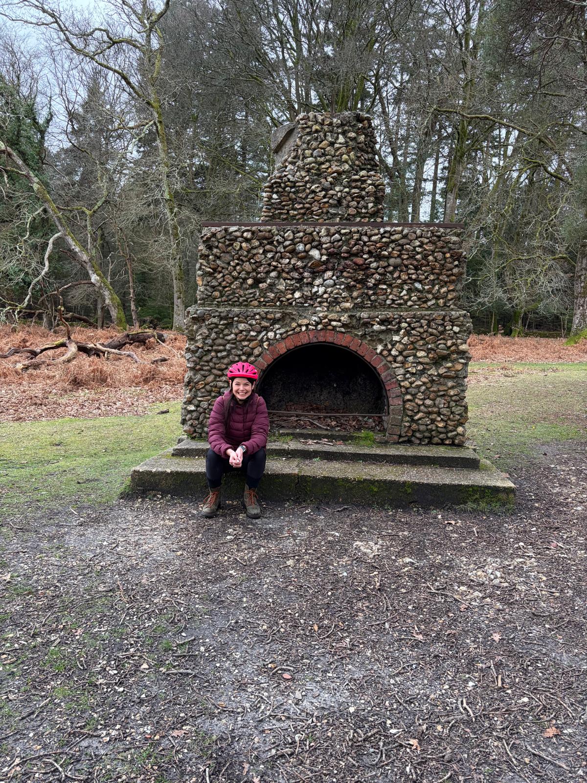 Me sat down in front of the remnants of a fireplace.